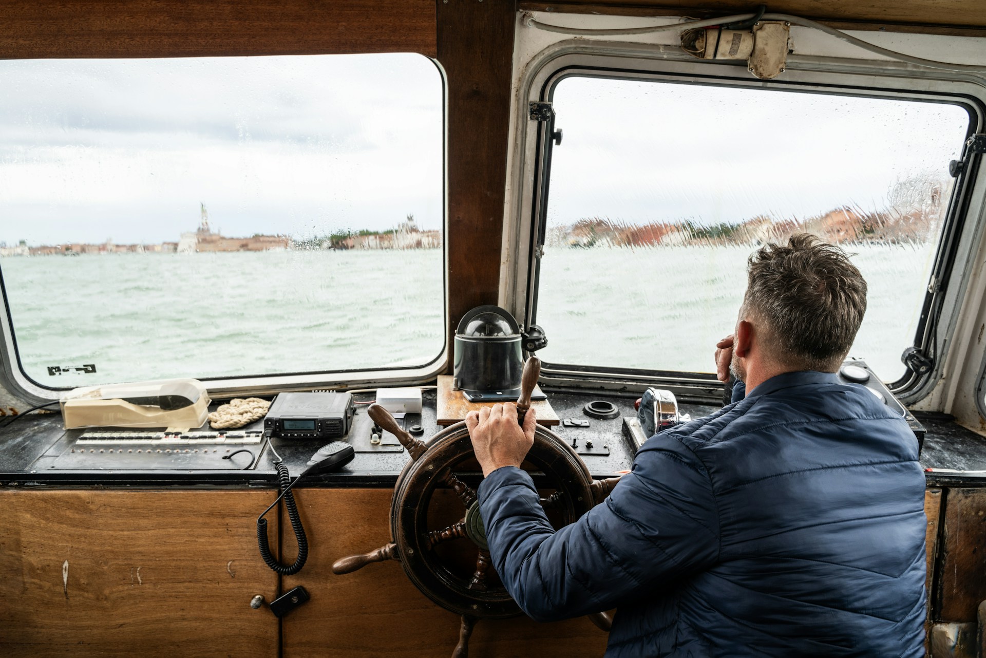 Man steering a boat on the water